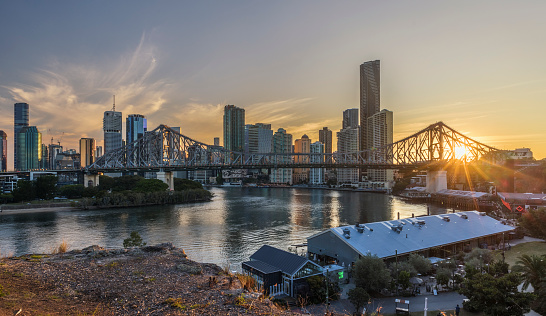 Sunset over the city of Brisbane overlooking the majestic steel Story Bridge, Brisbane River, Brisbane City buildings and the entertainment precinct of Howard Smith Wharves.