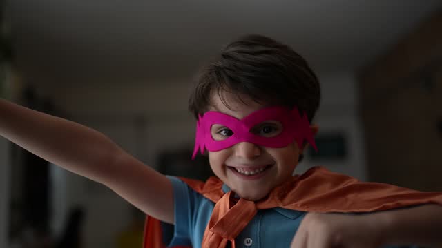 Portrait of a boy playing as superhero at home