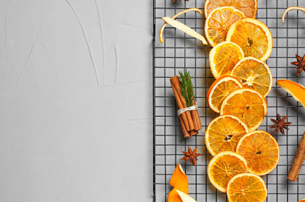 istock Flat lay composition with dry orange slices, anise stars and cinnamon sticks on light grey table. Space for text 1495502632