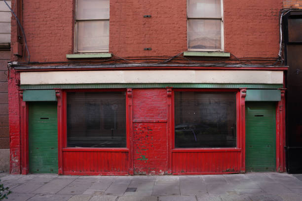 istock Run down old building with peeling paint and vacant shuttered store 1495502680