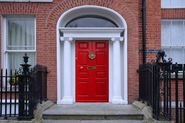 Entrance to old brick townhouse with bright red door stock photo
