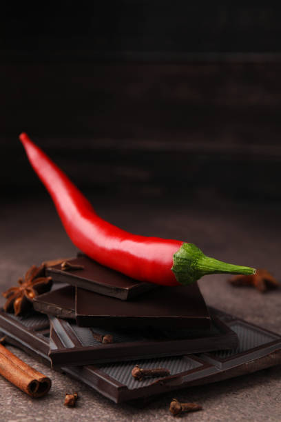 istock Delicious chocolate, fresh red chili pepper and spices on grey textured table, closeup 1495504865