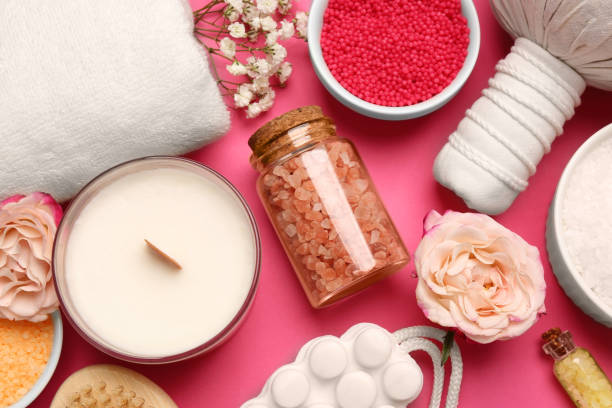 istock Sea salt and different spa products on pink background, flat lay 1495506418