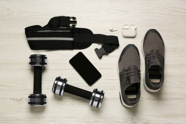istock Flat lay composition with black waist bag on white wooden table 1495506443