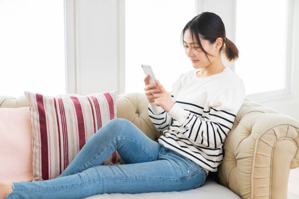 istock attractive Asian woman using a smart phone 1495506515