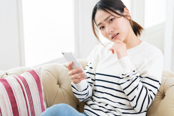 istock attractive Asian woman using a smart phone,think, 1495506524