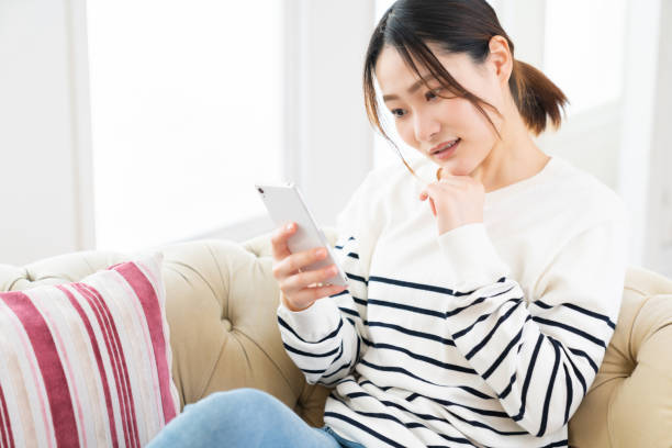 istock attractive Asian woman using a smart phone,think, 1495506545