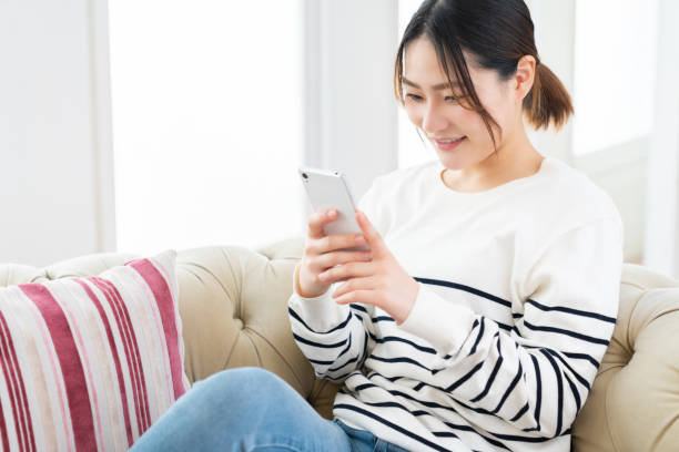 istock attractive Asian woman using a smart phone 1495506550