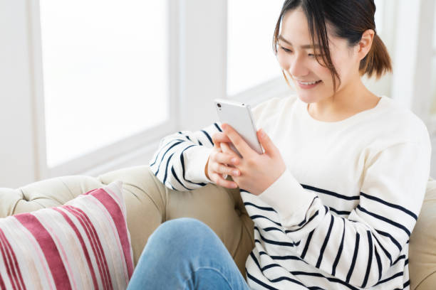 istock attractive Asian woman using a smart phone 1495506558