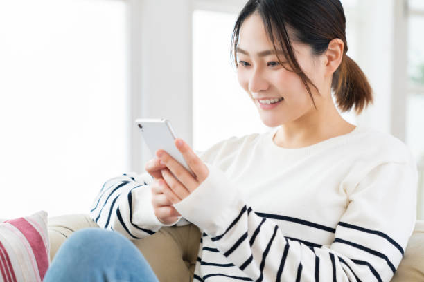 istock attractive Asian woman using a smart phone 1495506644