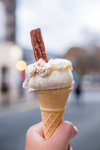 istock Hand holding Ice Cream Cone with Chocolate Flakes, with blur background 1495522898