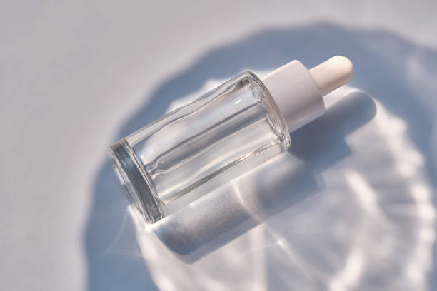 istock Serum bottle on a blue background with glare. 1495531461