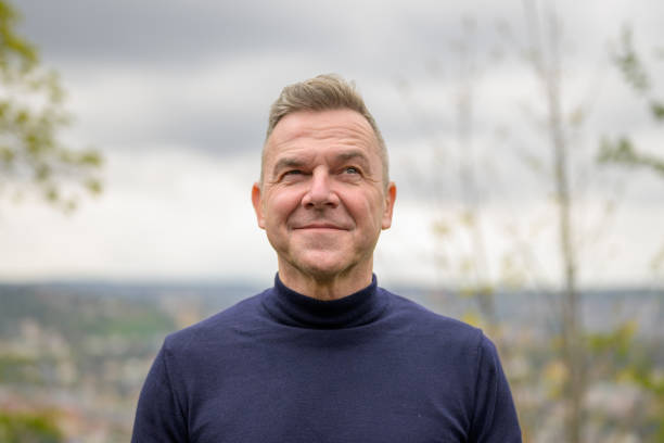 istock Man wearing a blue sweater standing on a mountain 1495539209