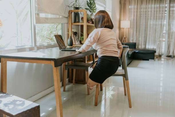 istock Active Thai transgender woman with disability E-learning at home. 1495543263