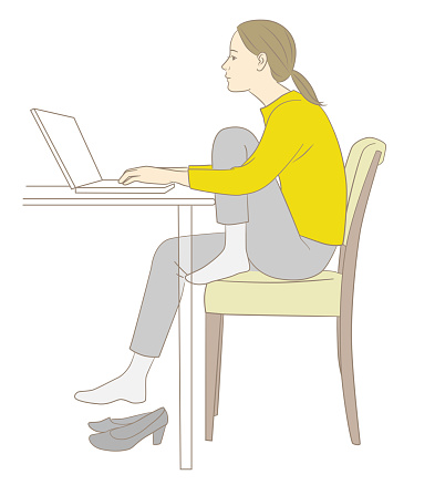 Stooped woman doing desk work with standing knees