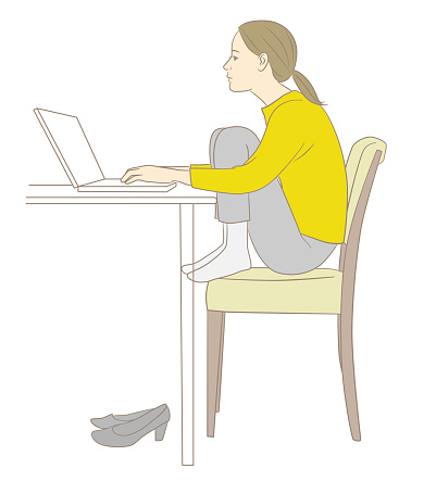 A stooped woman doing desk work in a gym sitting