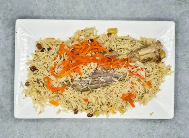 Mutton kabuli pulao served in dish isolated on background top view of indian spices and pakistani food