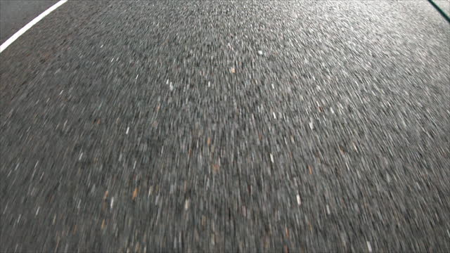 Pov view of drive car at high speed through gray asphalt on highway. Transition Highway auto
