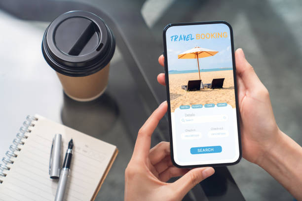 istock Hands holding smartphone with application booking flight travel search ticket holiday and hotel on website, concept technology online marketing and promotion. 1495553370