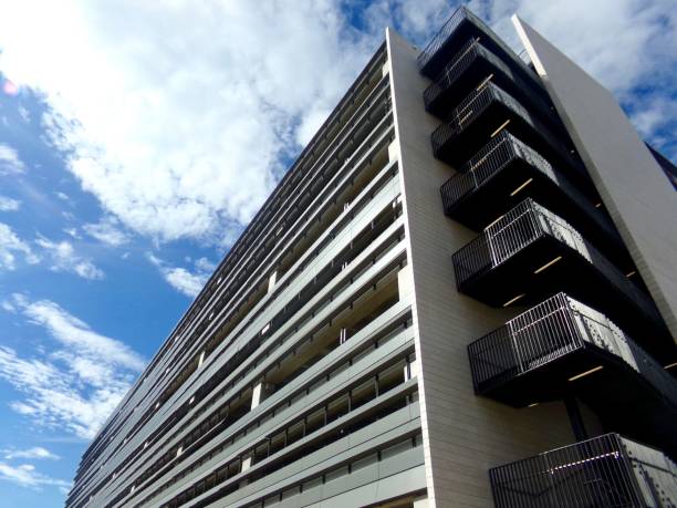 istock Low angle of a modern residential building against a cloudy blue sky 1495554208