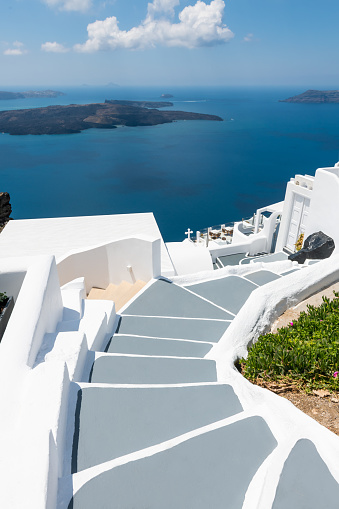 White architecture in Santorini island, Greece. Blue sea and the blue sky with clouds. Travel and summer vacations concept