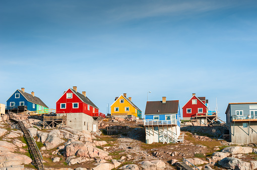 Colorful houses on the shore of Atlantic ocean in Ilulissat, western Greenland. Summer landscape