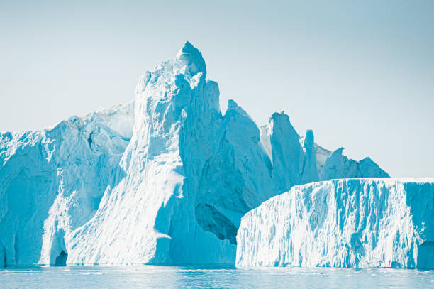 Big blue icebergs in Atlantic ocean, Ilulissat icefjord, Greenland. Big blue icebergs in Atlantic ocean, Ilulissat icefjord, western Greenland. Summer landscape ilulissat icefjord stock pictures, royalty-free photos & images
