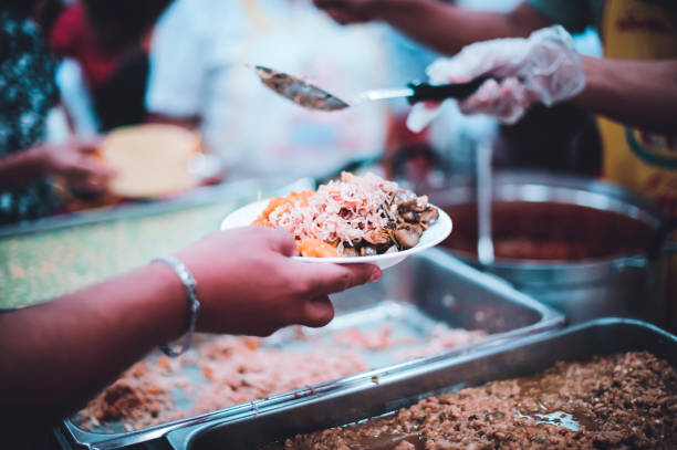 istock Feeding the poor to hands of a beggar. Poverty concept 1495558316
