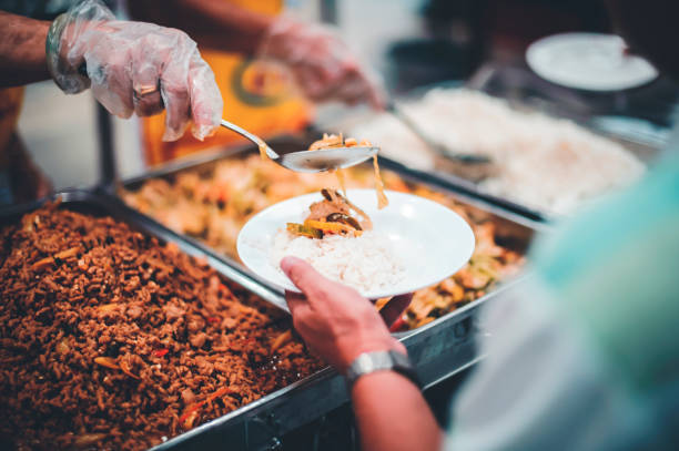 istock Feeding the poor to hands of a beggar. Poverty concept 1495558363