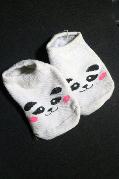 istock Cute baby socks with panda faces 1495558750
