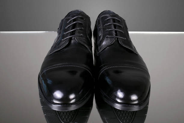istock Classic men's black leather shoes on a gray background 1495559166