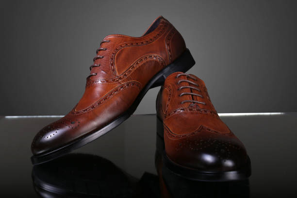 istock Classic men's brown leather shoes on a gray background 1495559789