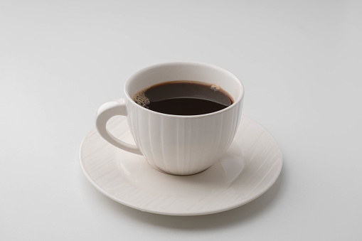 Black coffee in white cup isolated on white background with clipping path