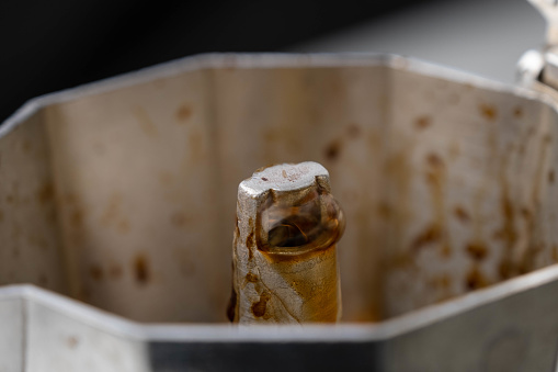 Coffee in mokapot, Coffee cream boiled in moka pot close up. Coffee flowing on the coffee machine.