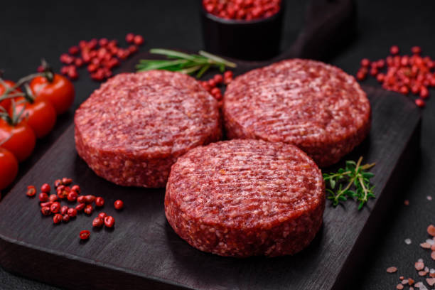 istock Fresh raw ground beef burger patty with salt and spices 1495562033