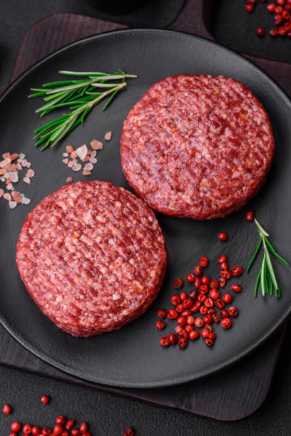 istock Fresh raw ground beef burger patty with salt and spices 1495562247