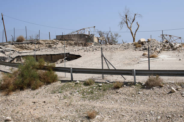 istock A ruined place: a failure in the road and a ruined room 1495562720