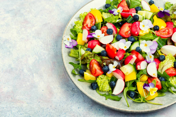 istock Tasty summer salad with edible flowers 1495564259