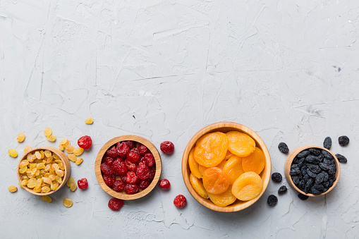 Bowl with different dried fruits on table background, top view. Healthy lifestyle with copy space.