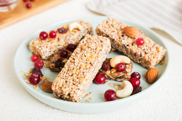 istock Various granola bars on table background. Cereal granola bars. Superfood breakfast bars with oats, nuts and berries, close up. Superfood concept 1495565227