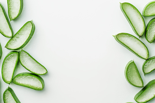 Fresh Aloe vera slice with aloe gel on white background. Aloe vera leaf slice background for herbal medicine or skin care treatment.