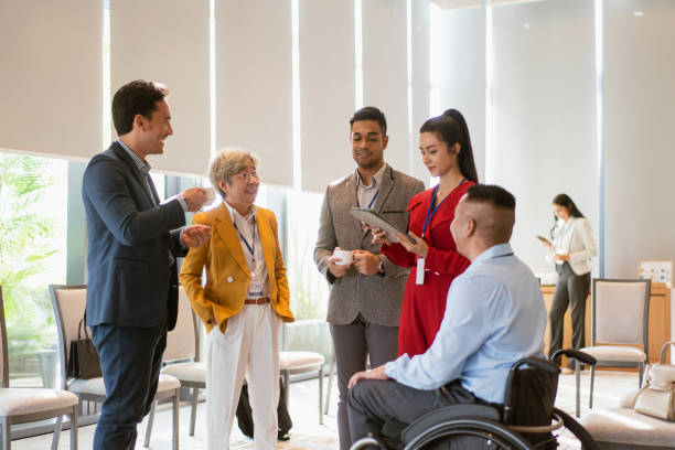 Networking session between a diverse group of business individuals young and old, abled and disabled stock photo