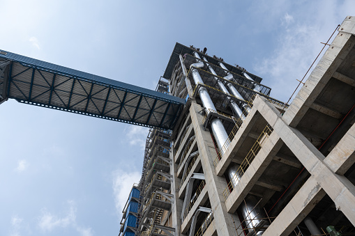 Tower Crane with an American flag near a modern office building under construction