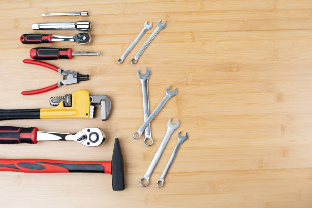 istock A set of working tools, a hammer, a screwdriver, adjustable spanner, sockets for repair on a bamboo, wooden background 1495570509