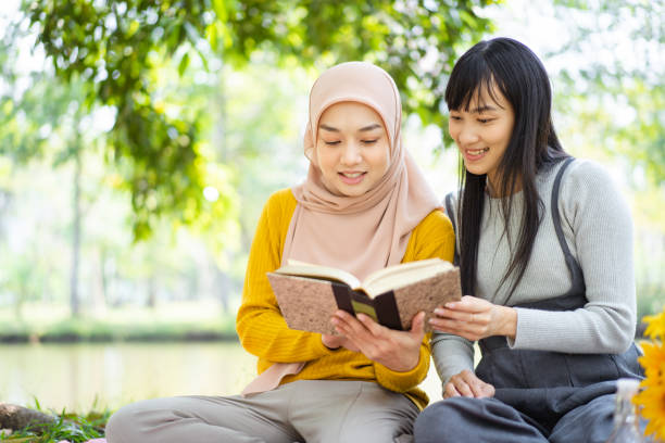 istock Women reading a book together. 1495572140