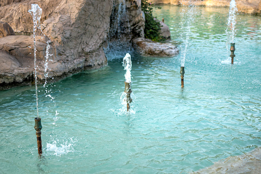 Water green and turquoise texture in a fountain pool