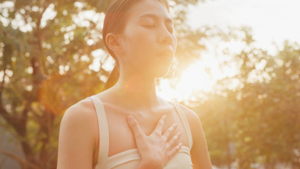 Young Asian women healthy lifestyle practice yoga outdoors standing in city park. Healthy lifestyle and exercises. Young Asian women healthy lifestyle practice yoga outdoors standing in city park. Healthy lifestyle and exercises concept. mental wellbeing stock pictures, royalty-free photos & images