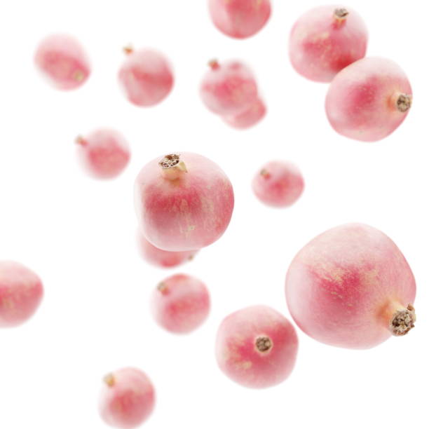istock Juicy pomegranate and its half with leaves. Isolated on a white background. 1495578755