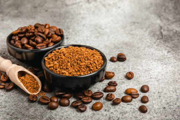 istock Instant coffee and coffee beans on a black stone background. Aromatic coffee drink. Place for text. Space for copy text 1495579493