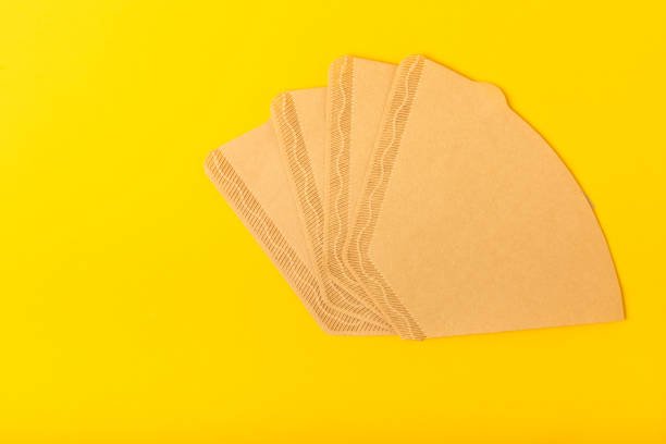 istock Coffee filter with ground powder on background. fragrant coffee beans for an energizing and invigorating drink. Hand Drip Coffee, Flat Lay of Manual Brew Coffee Tools. 1495580741